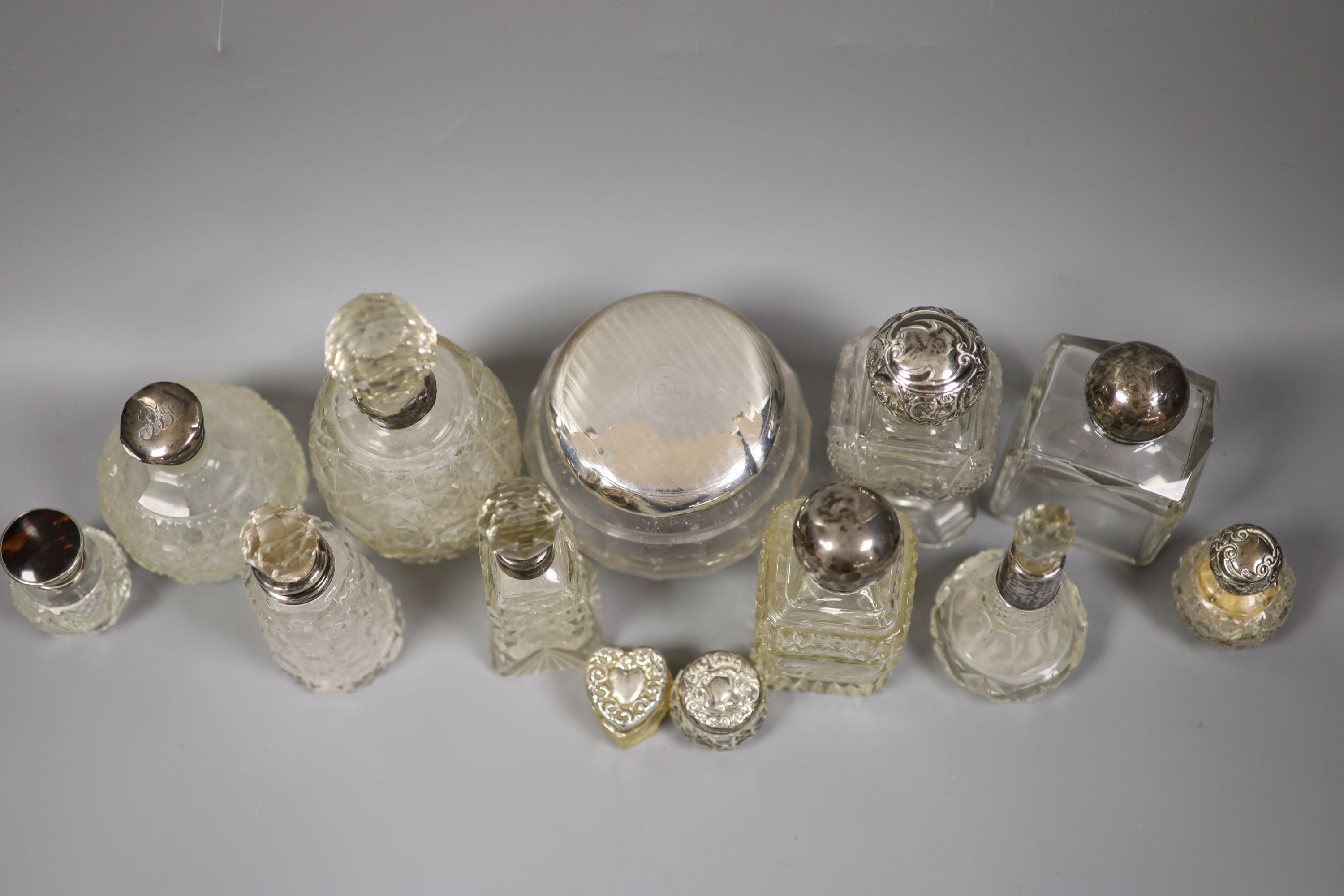 A collection of assorted silver mounted glass scent bottles, toilet jars etc. (a.f.)